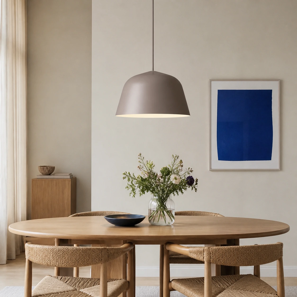 Taupe Eros pendant above a Nordic dining table