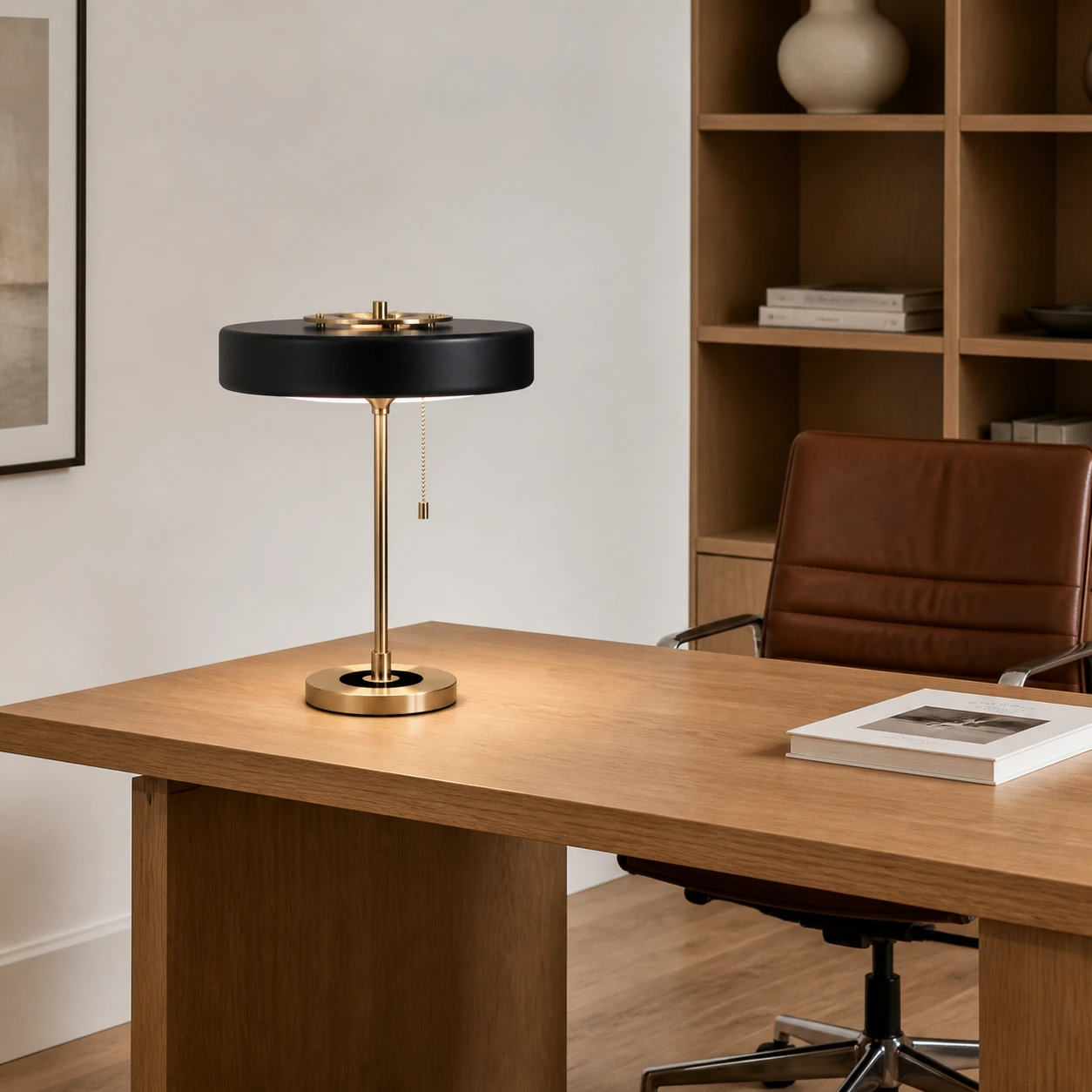 Black Revolve table lamp on a large oak desk in a modern study