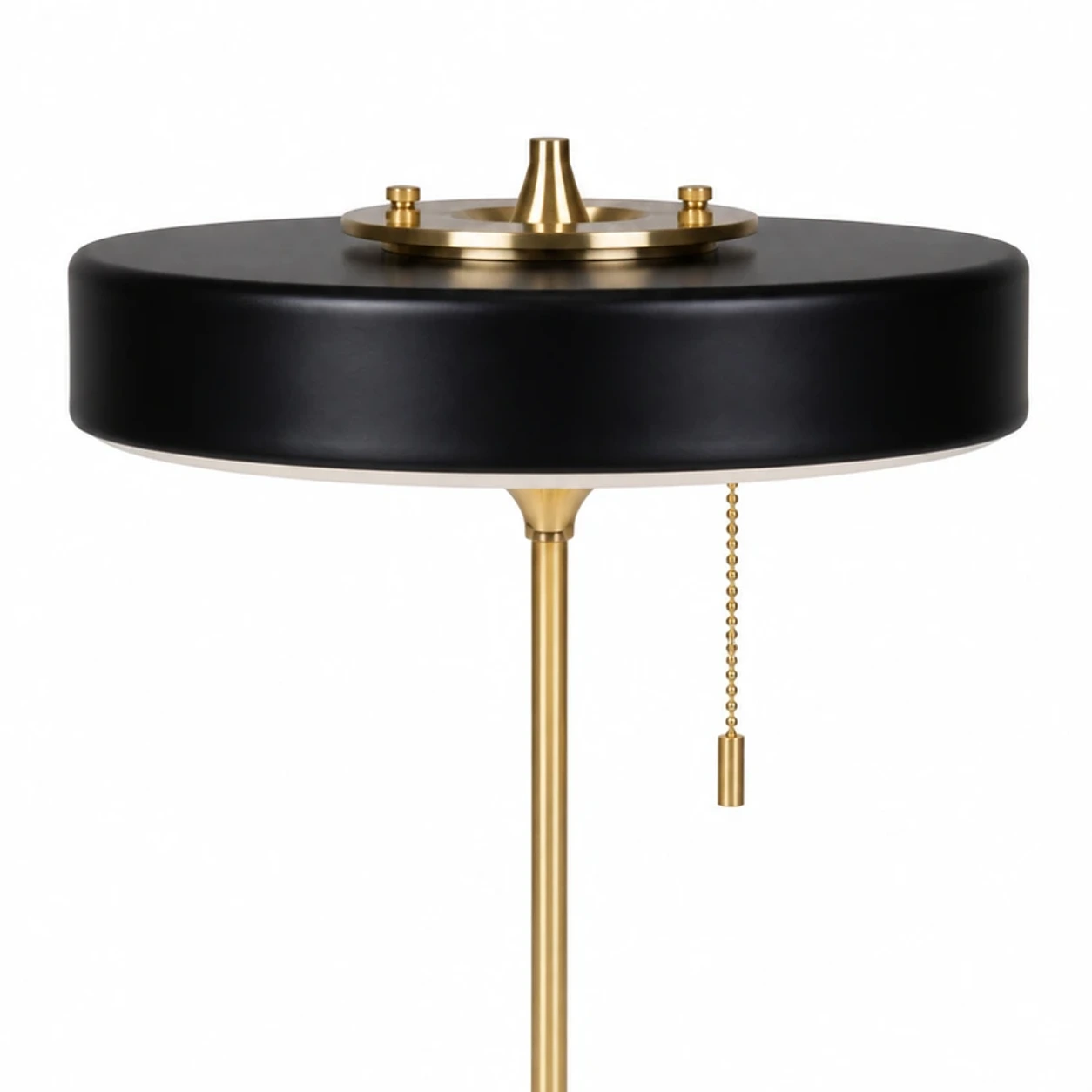 Close detail of the brass top finial and black circular shade