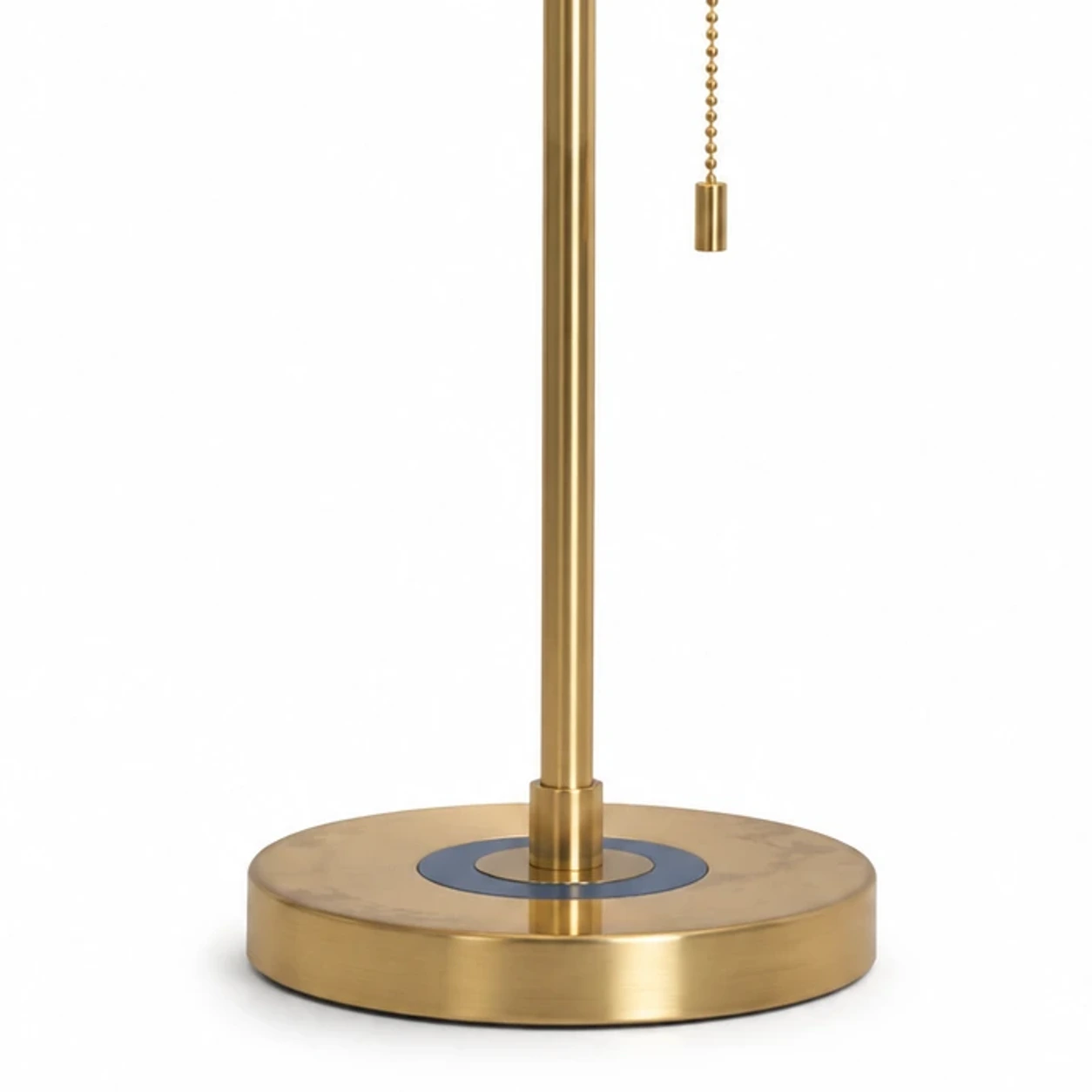 Close detail of the brushed brass stem and weighted base