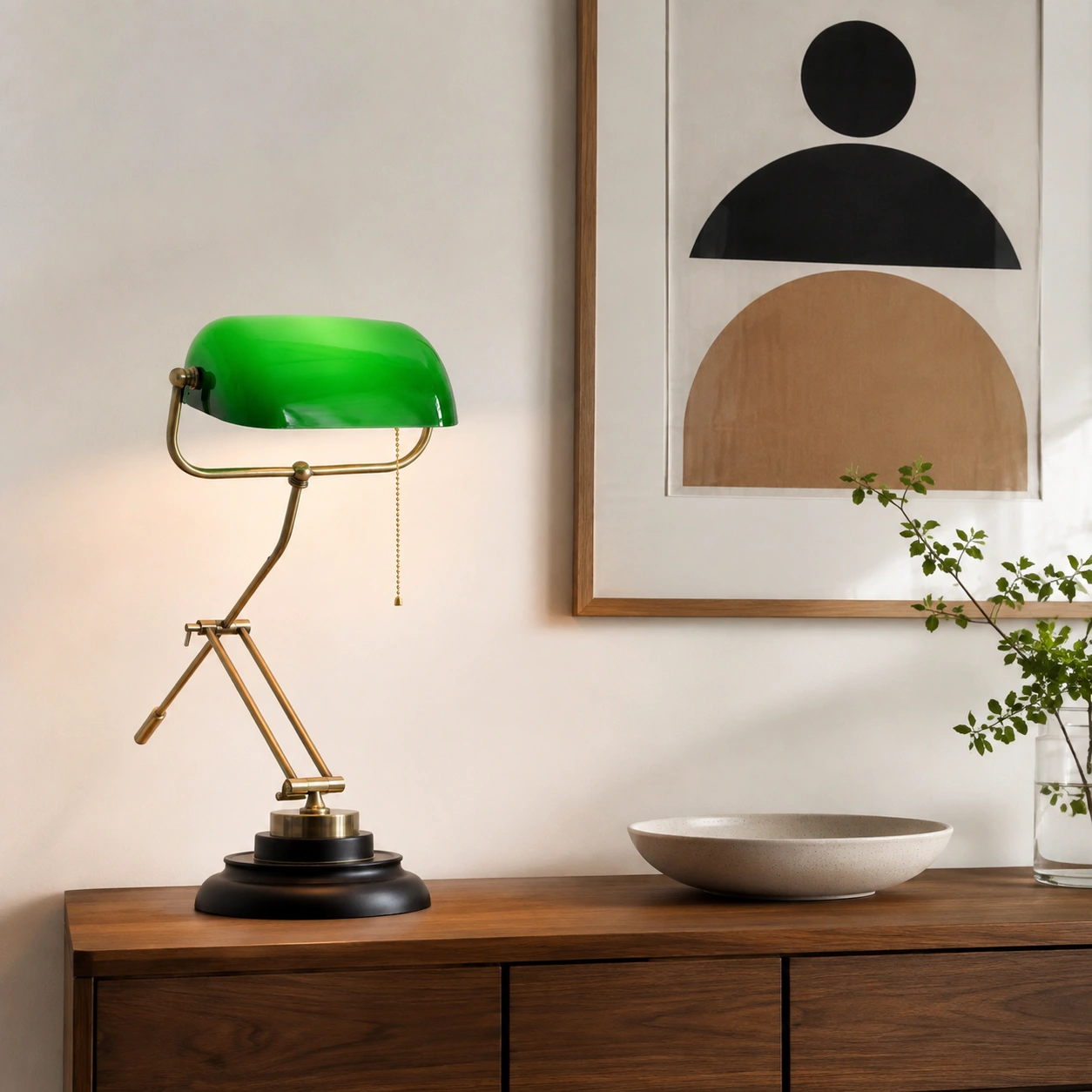 Green glass table lamp on a walnut console