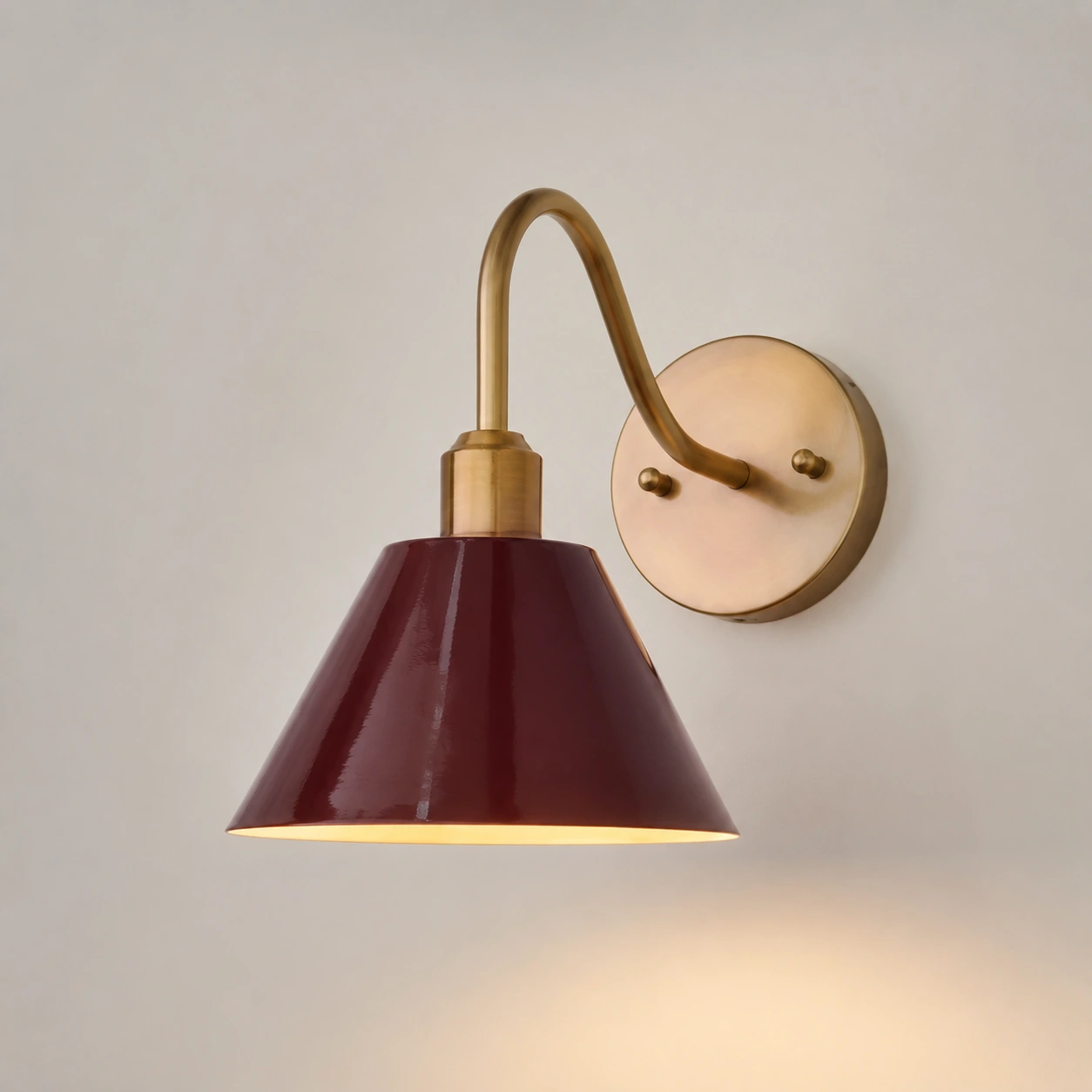 Burgundy Penia wall sconce on a light studio wall