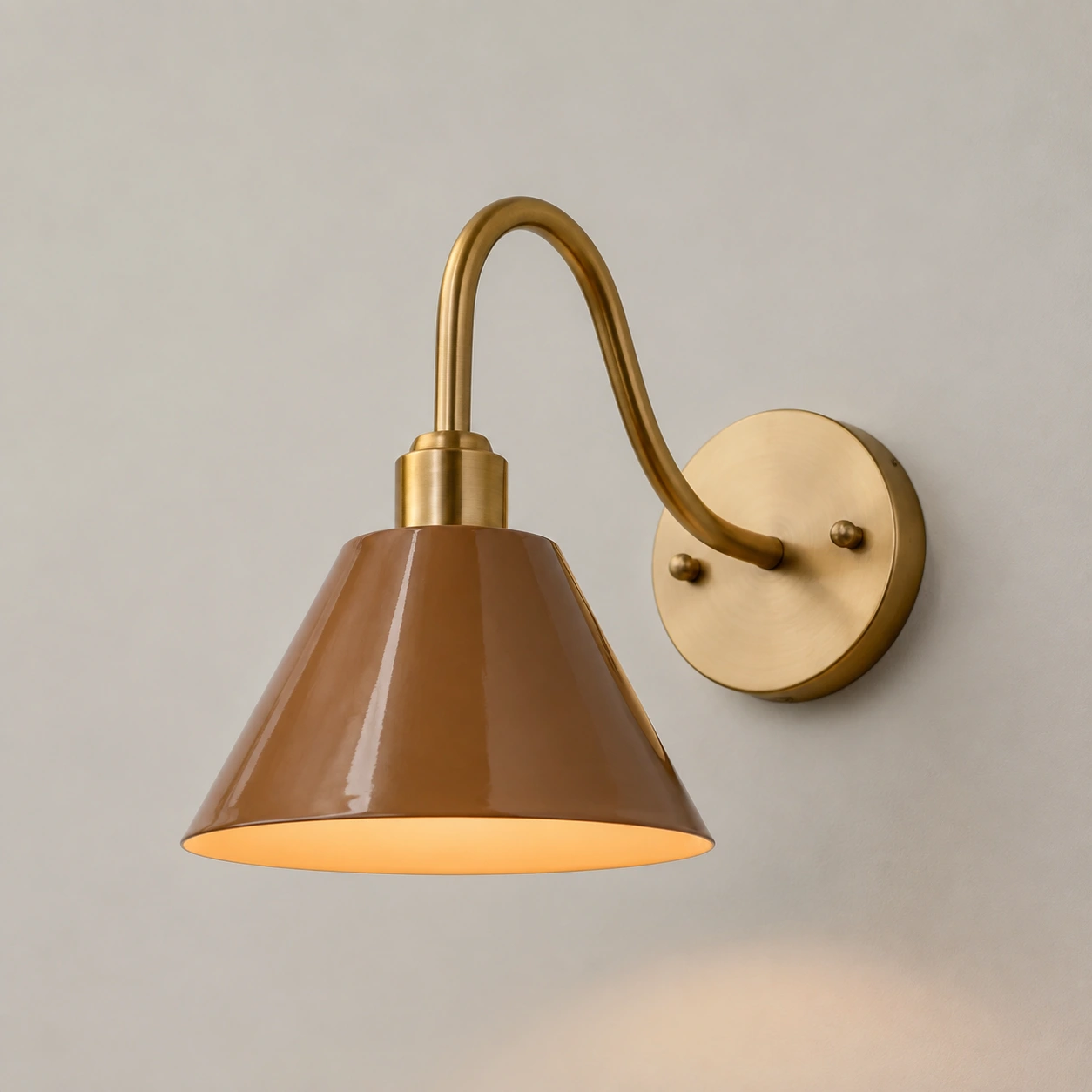 Deep Tan Penia wall sconce on a light studio wall