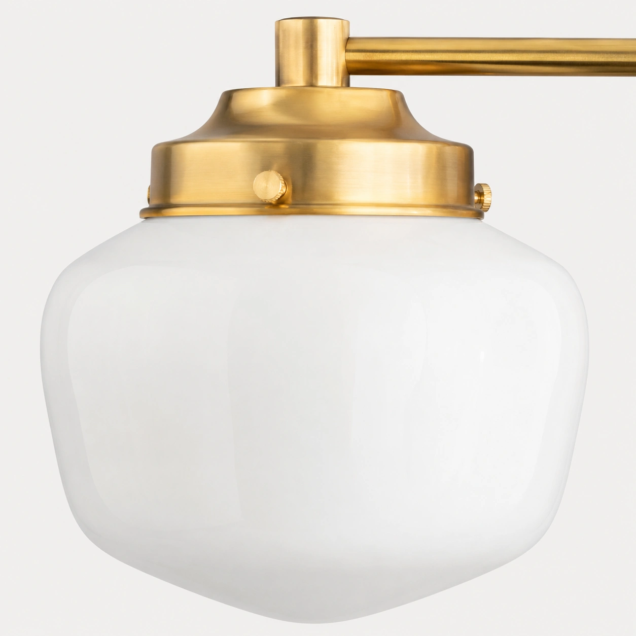 Close-up of the faceted milk glass shade and brass collar