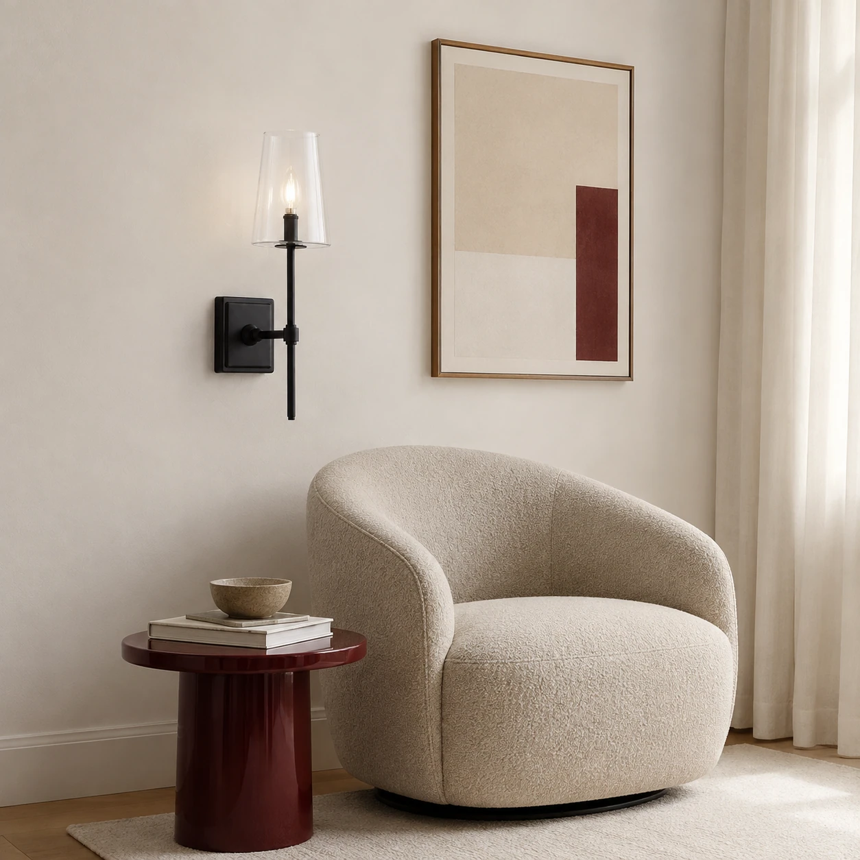 Single-head black Yve wall sconce in a reading corner