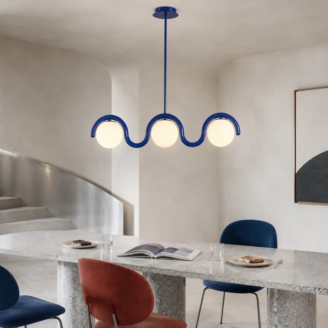 Auden blue wave chandelier in a contemporary terrazzo dining room