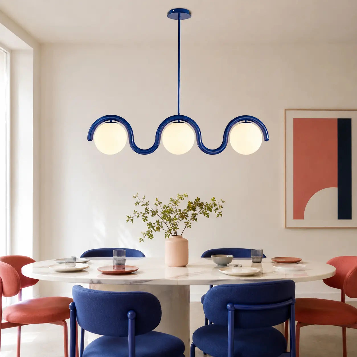 Auden blue three-globe wave chandelier in a colourful modern dining room
