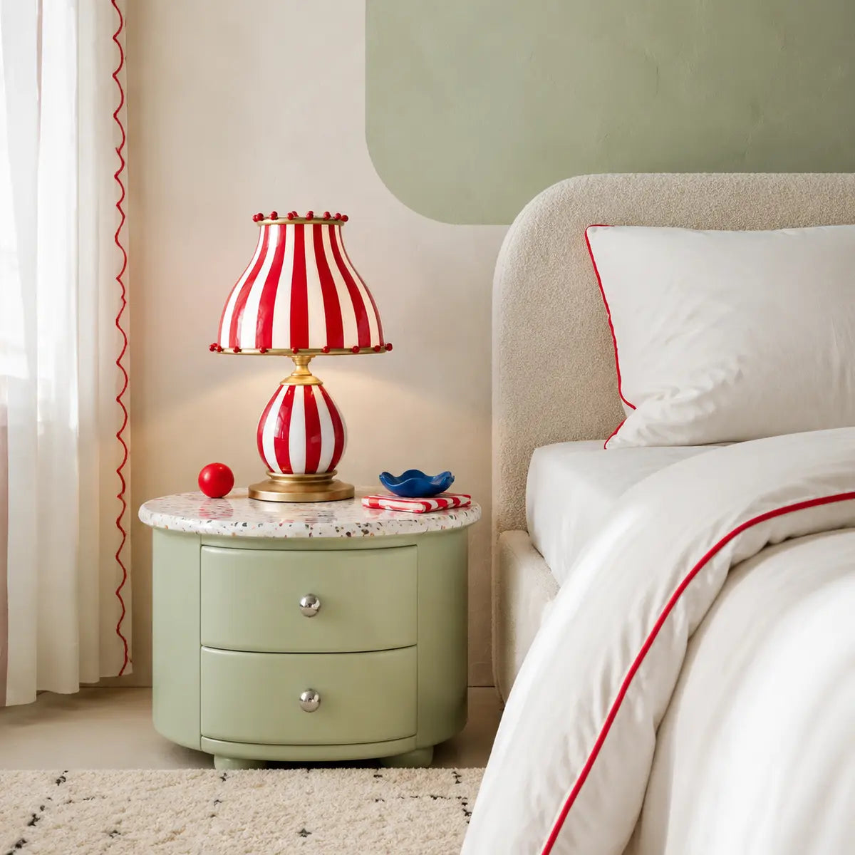 Odette striped table lamp on a sage metal bedside cabinet in a playful Nordic bedroom