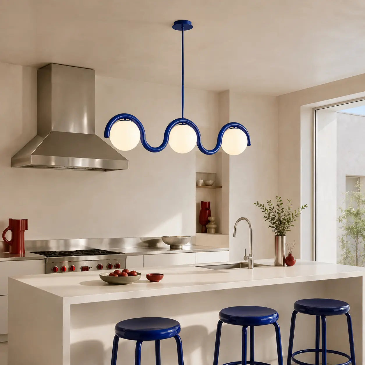 Three-quarter view of the Auden blue chandelier above a kitchen island