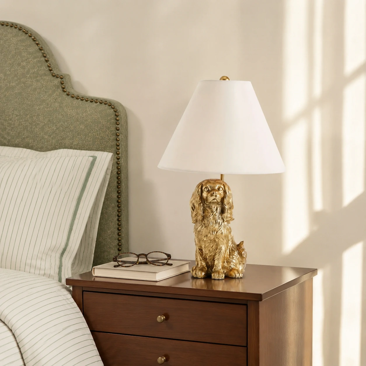 King Charles Cavalier lamp beside a bed