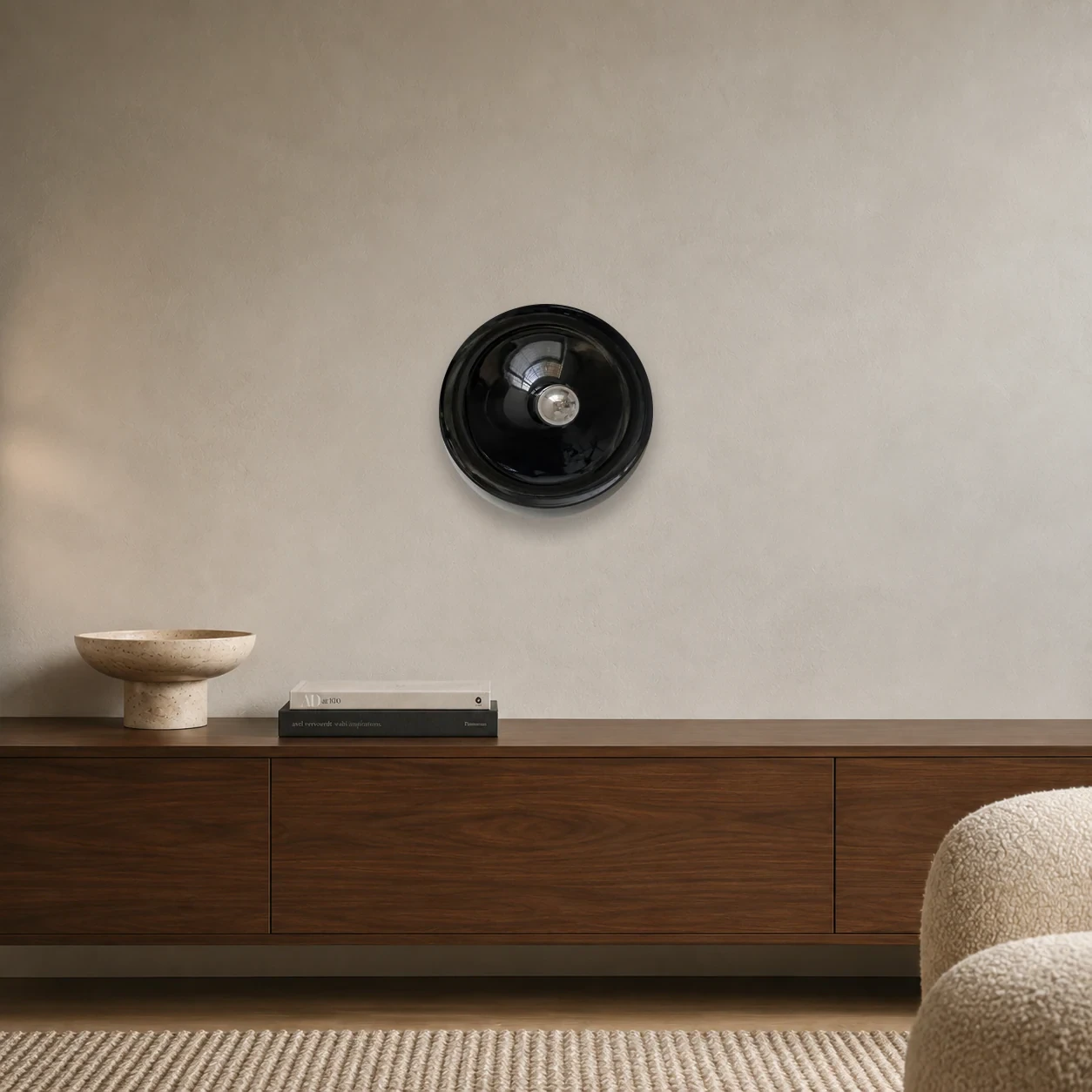 Black Ripple Rupert wall light centered above a walnut credenza