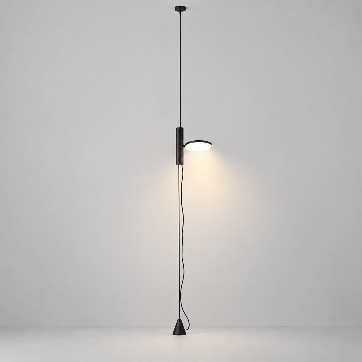 White Dieter floor lamp switched on in a minimal studio