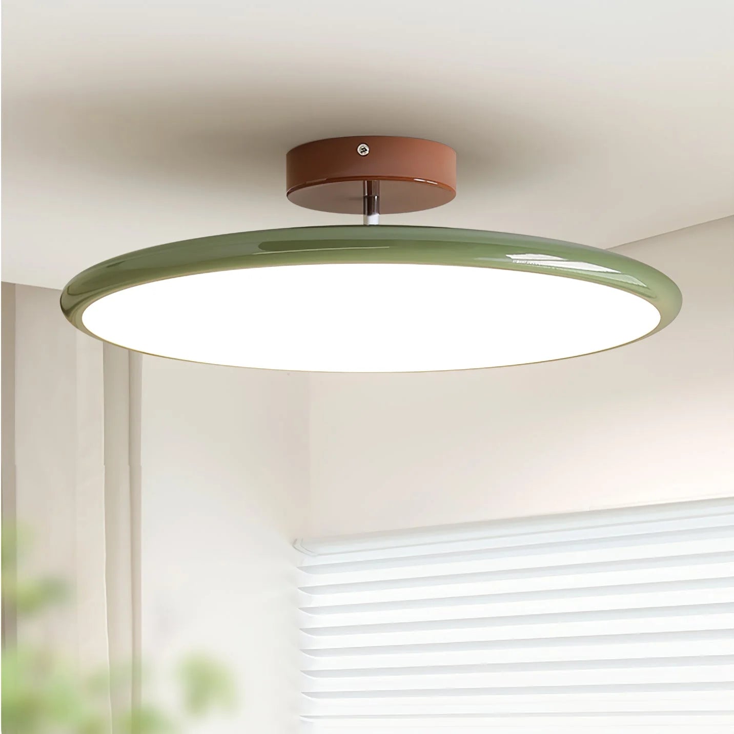 Odin adjustable disc ceiling light centered in a warm modern luxury room