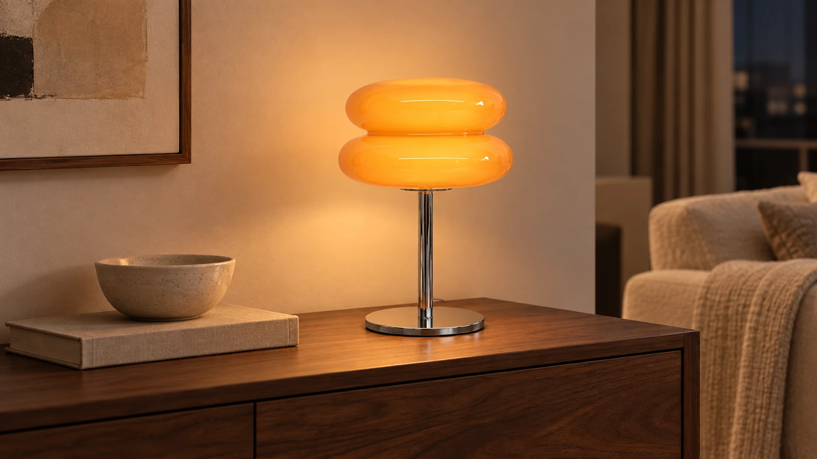 Light orange table lamp glowing on a console