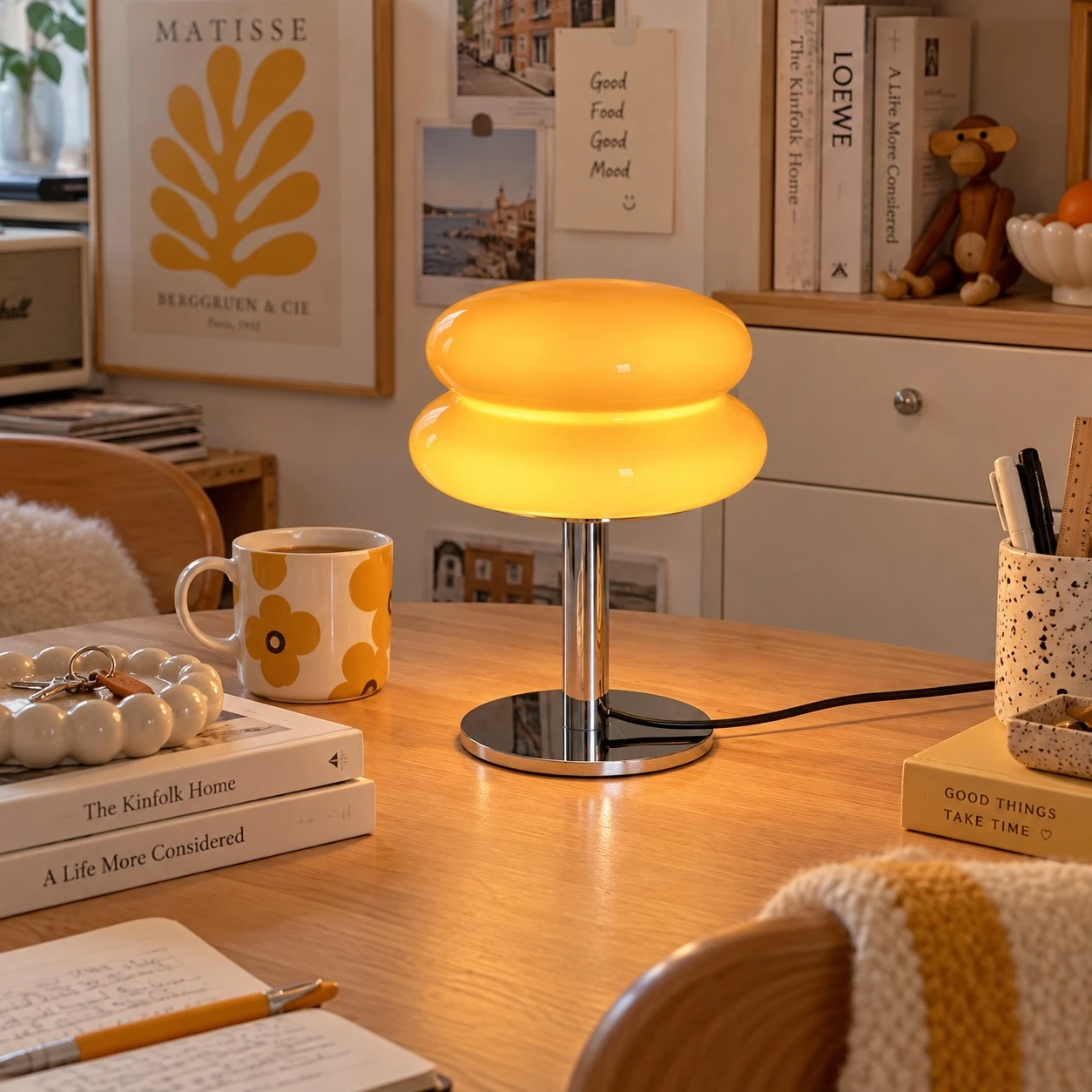 Orange Lollipop table lamp glowing on a home desk