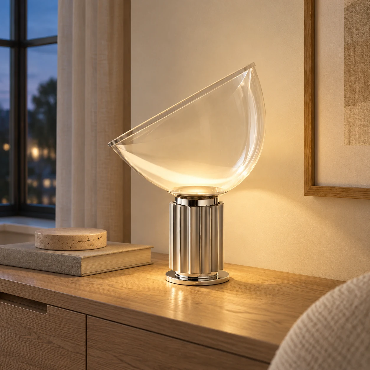 Silver Taci lamp at dusk