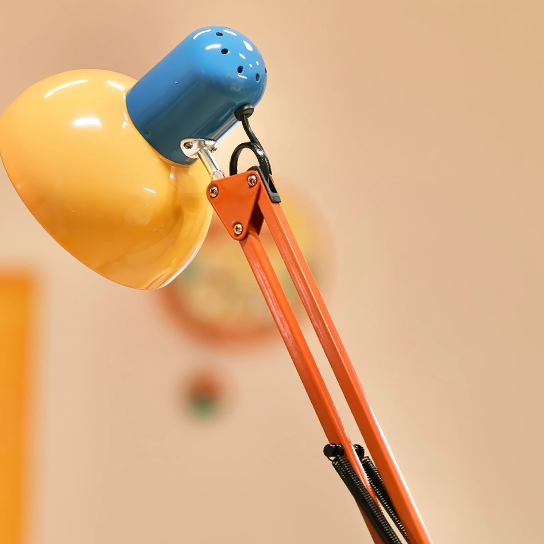 Real close-up of the metal shade and articulated floor lamp arm