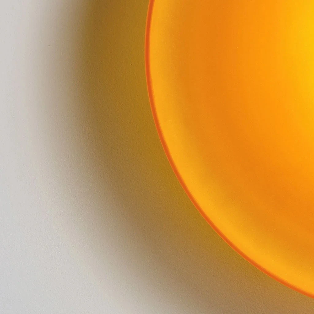 Warm light illuminating the orange glass edge
