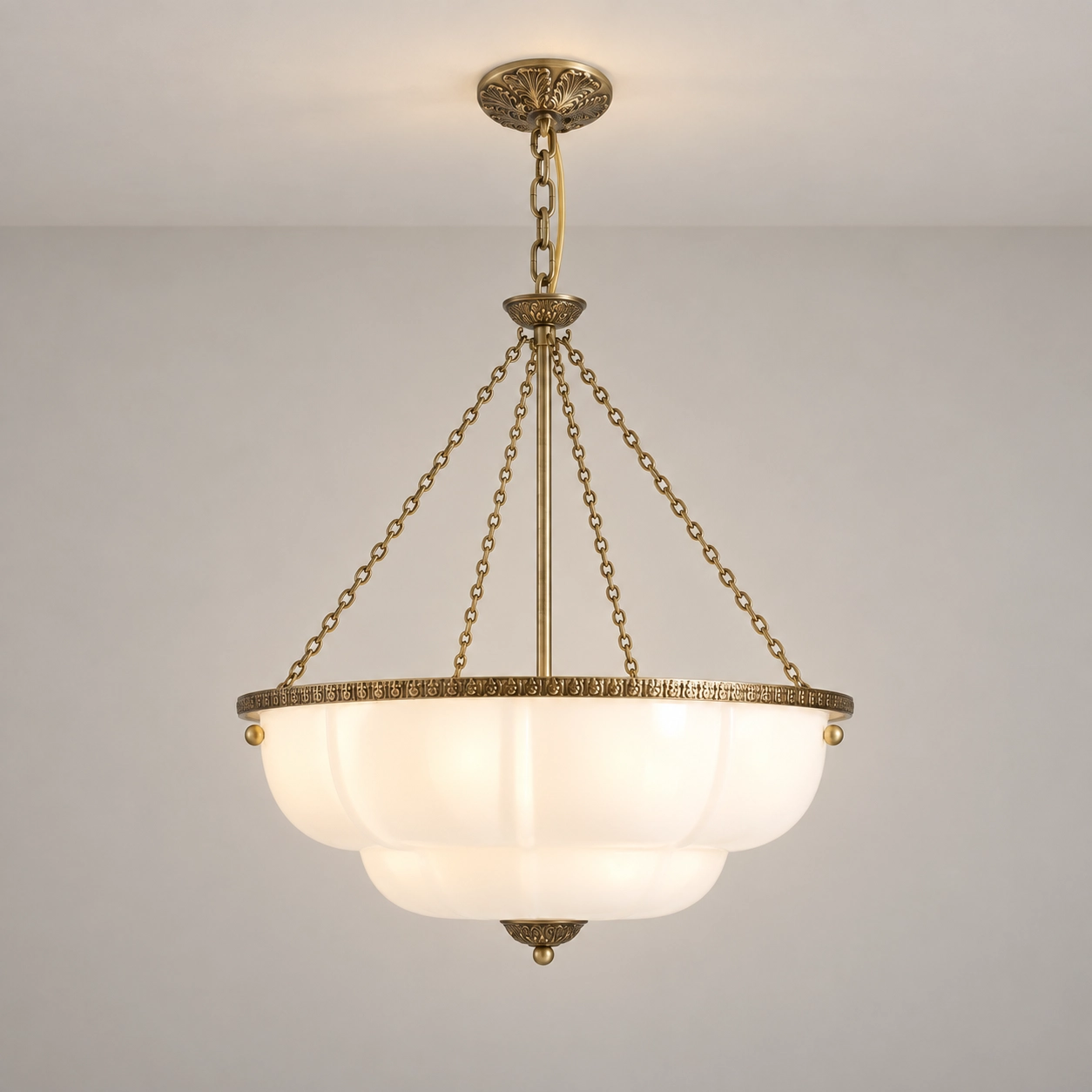 Milk white scalloped glass chandelier switched on in a pale studio
