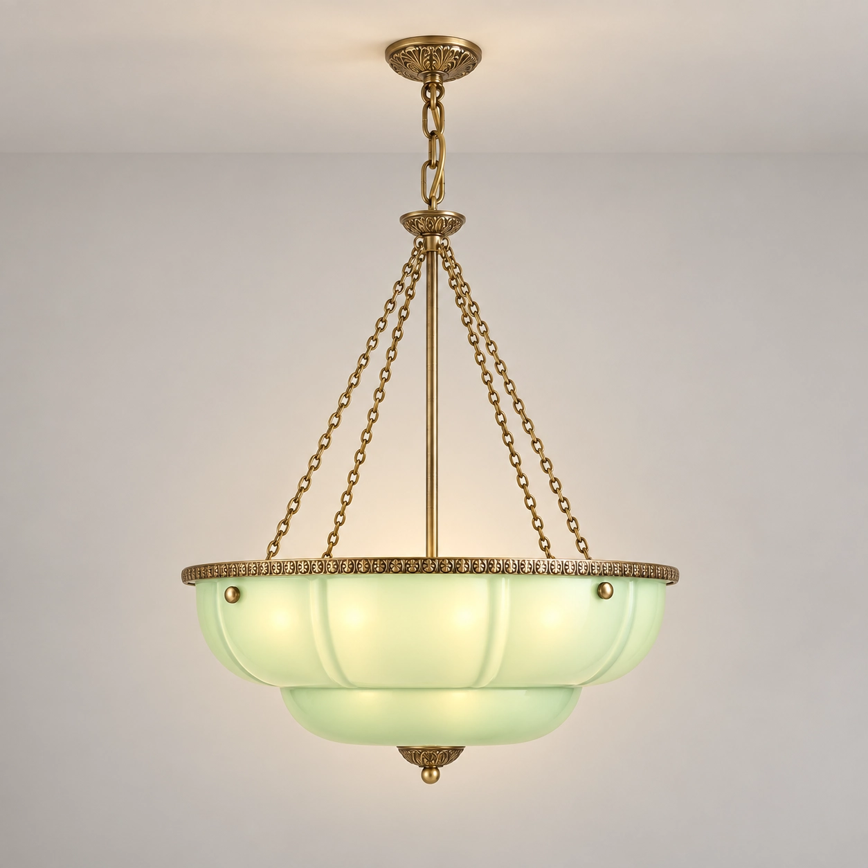 Celadon green scalloped glass chandelier switched on in a pale studio