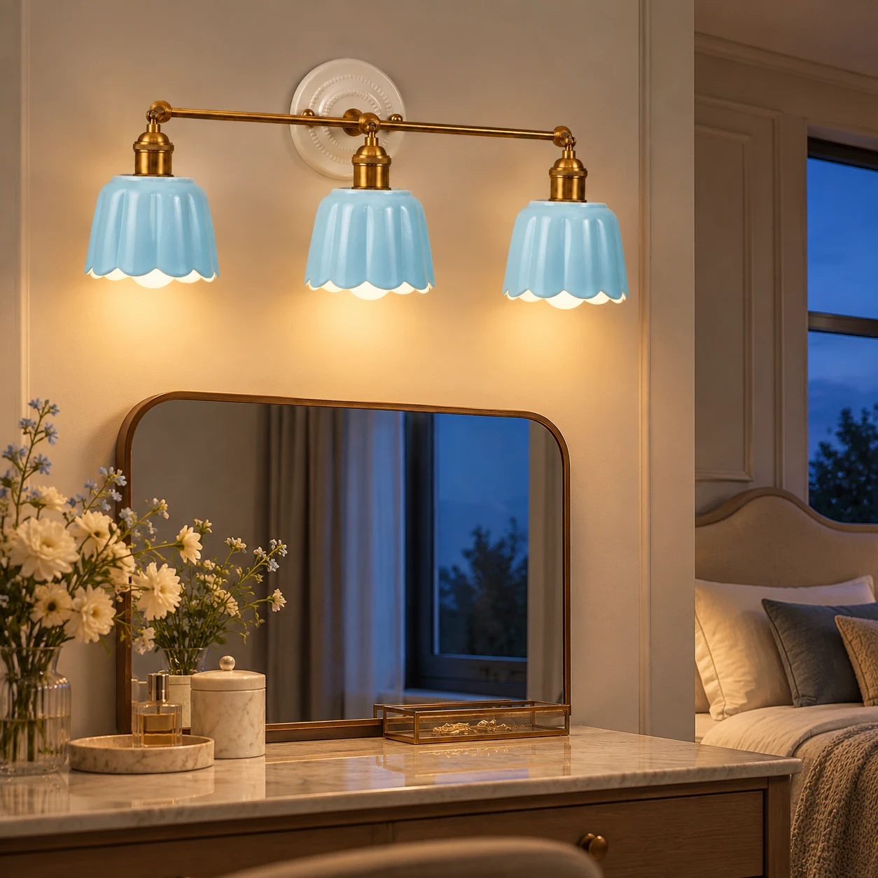 Blue three-light Fleur wall light at a bedroom vanity after dark