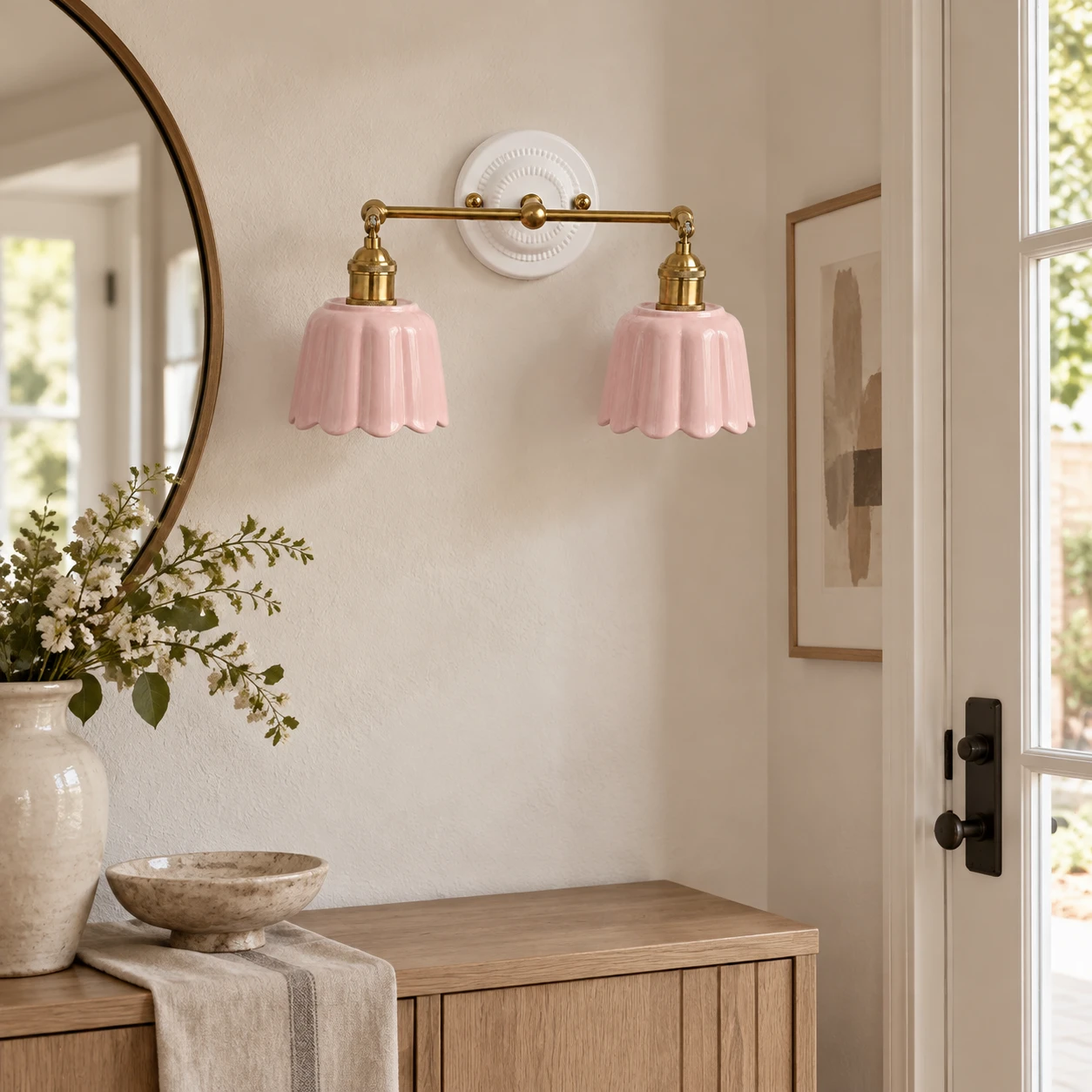 Pink two-light Fleur wall light installed in an entryway