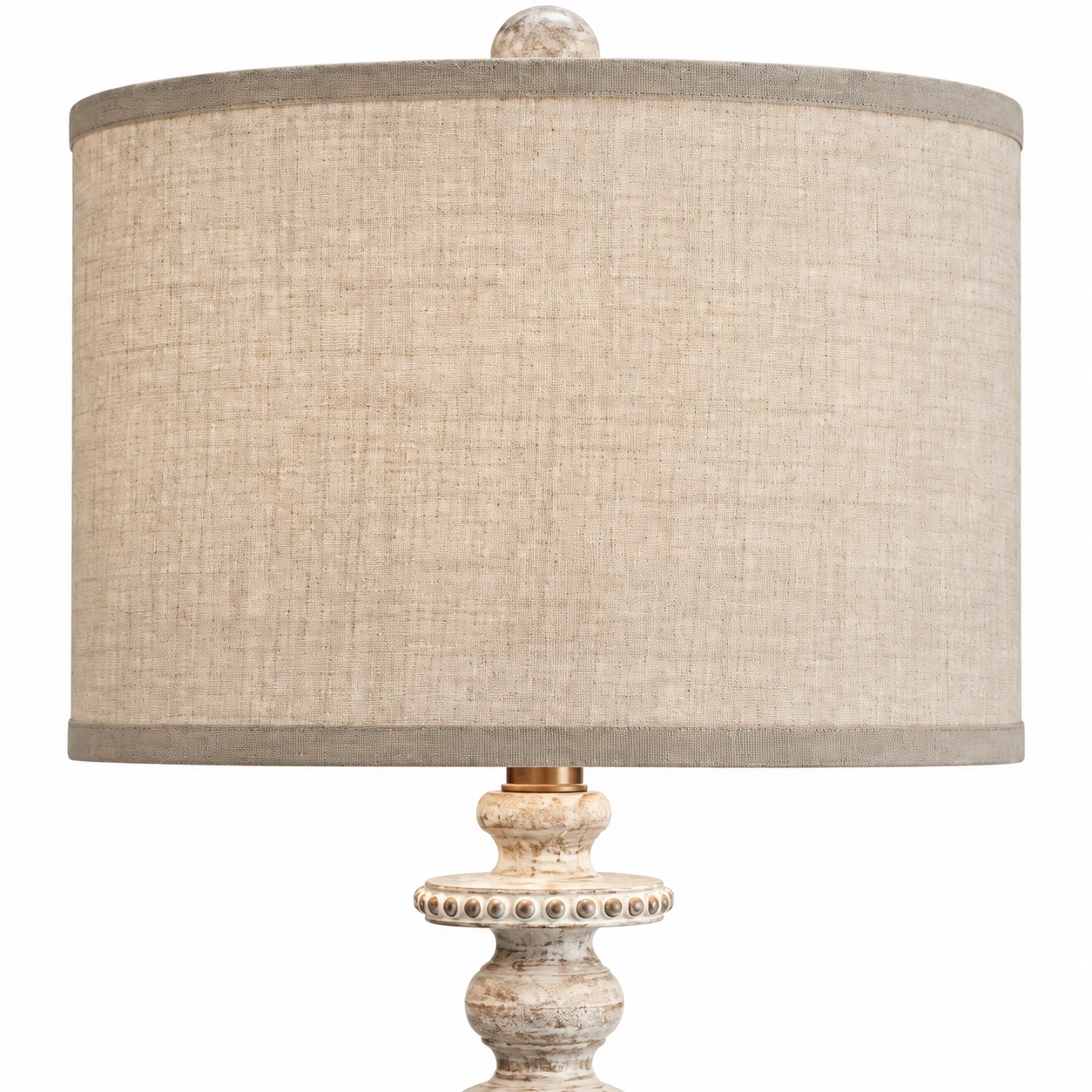 Neutral woven fabric shade, bound edge and carved top finial detail