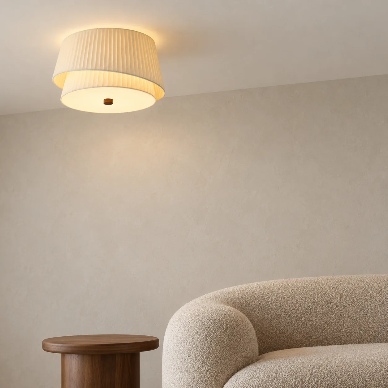 Near contextual view of the 50 cm pleated fabric flush mount above a boucle sofa