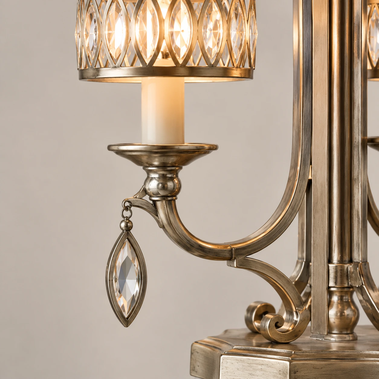 Close view of the faceted crystal shade, iron arm and hanging drop