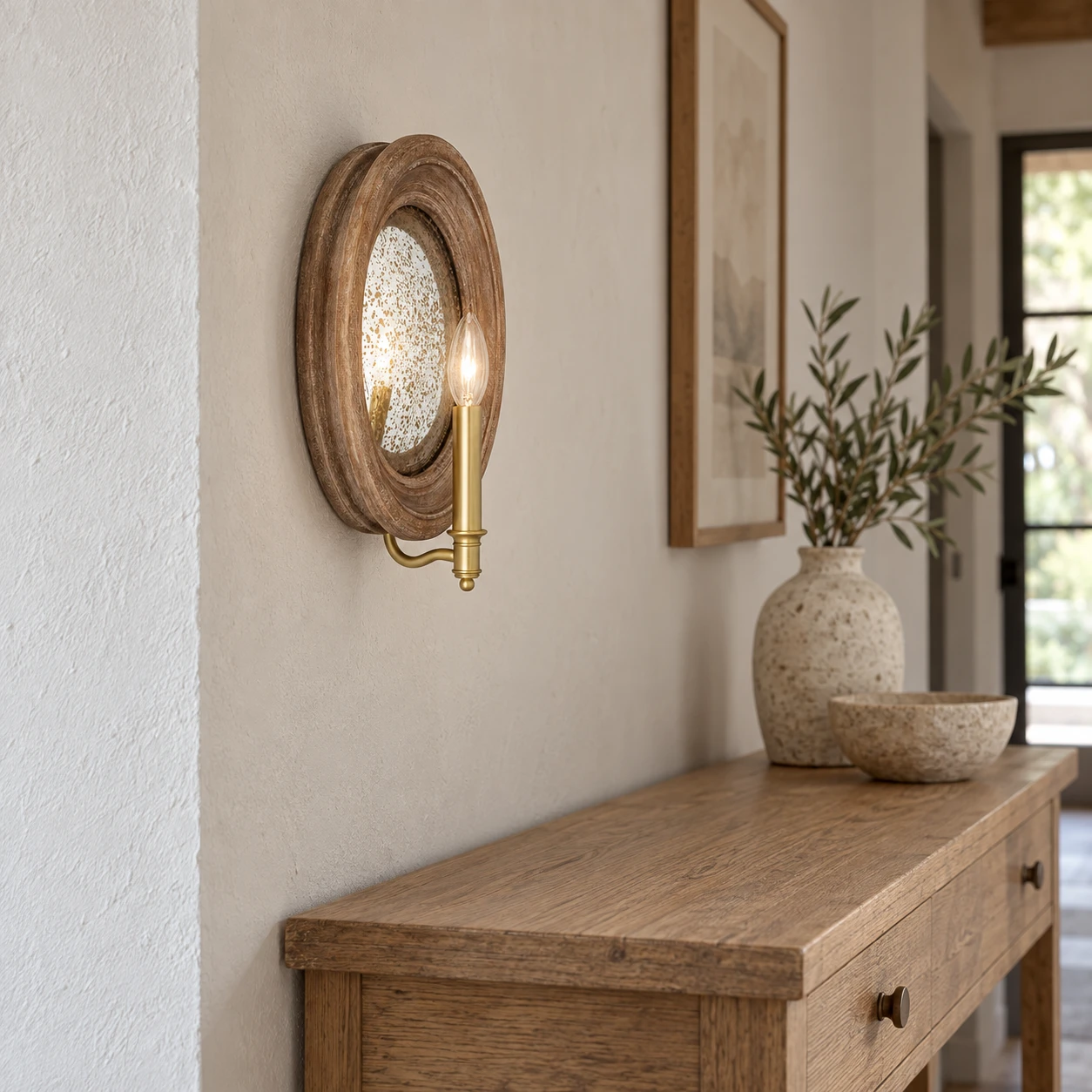 Carved wood mirror wall sconce installed on a left-facing entry wall