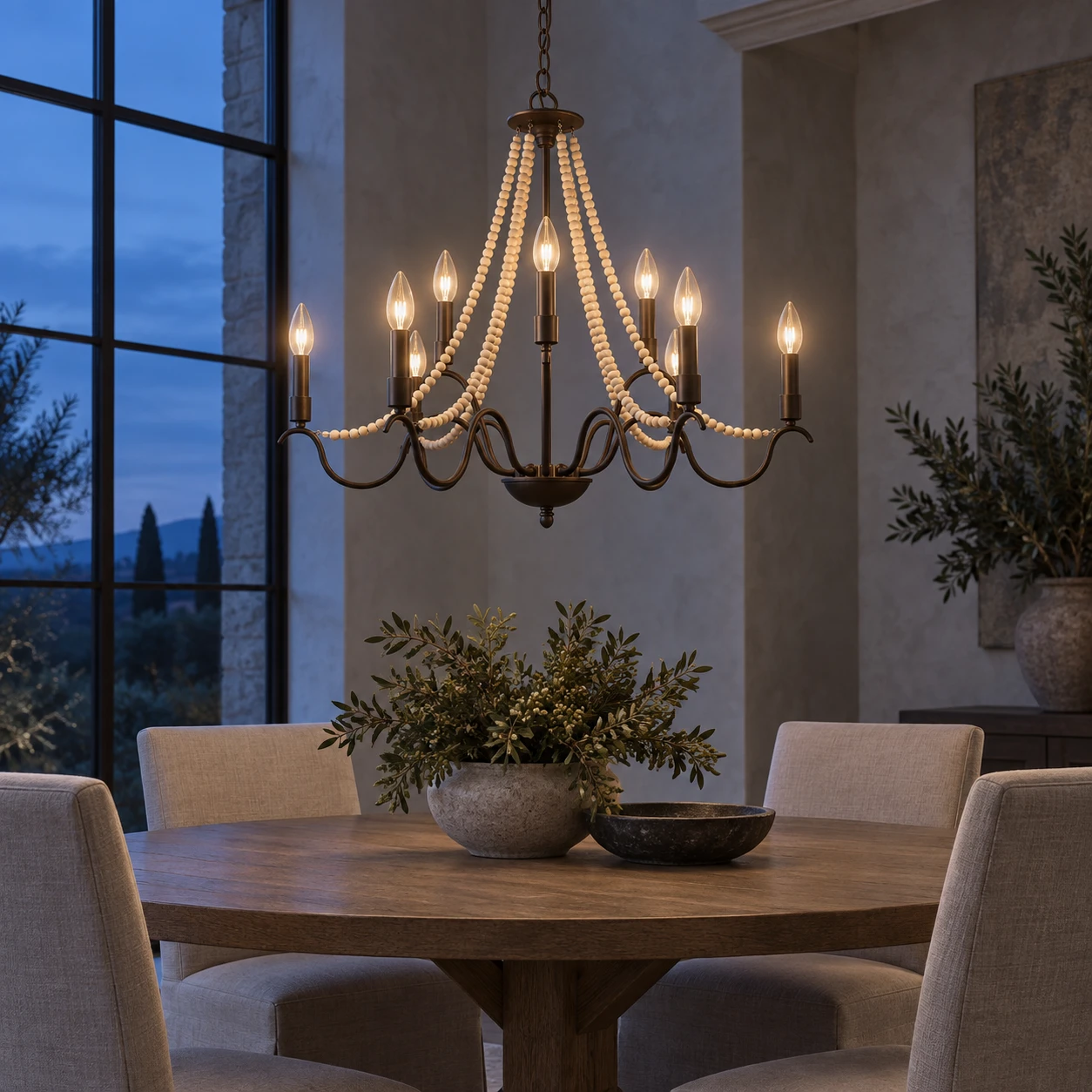 Wood bead chandelier glowing in an evening dining interior