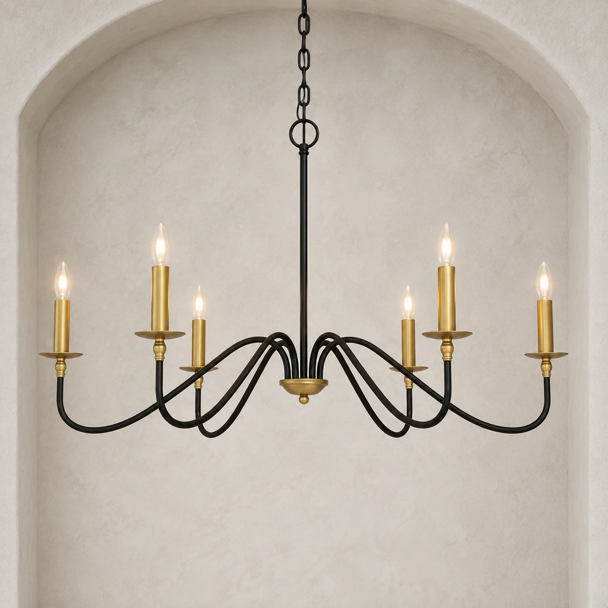 Arden vintage black iron six-light chandelier illuminated in a pale architectural niche