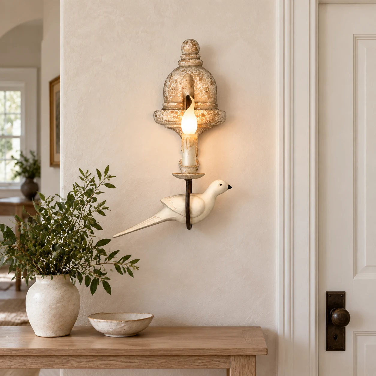 Mara single-head bird wall light above a limestone entry console