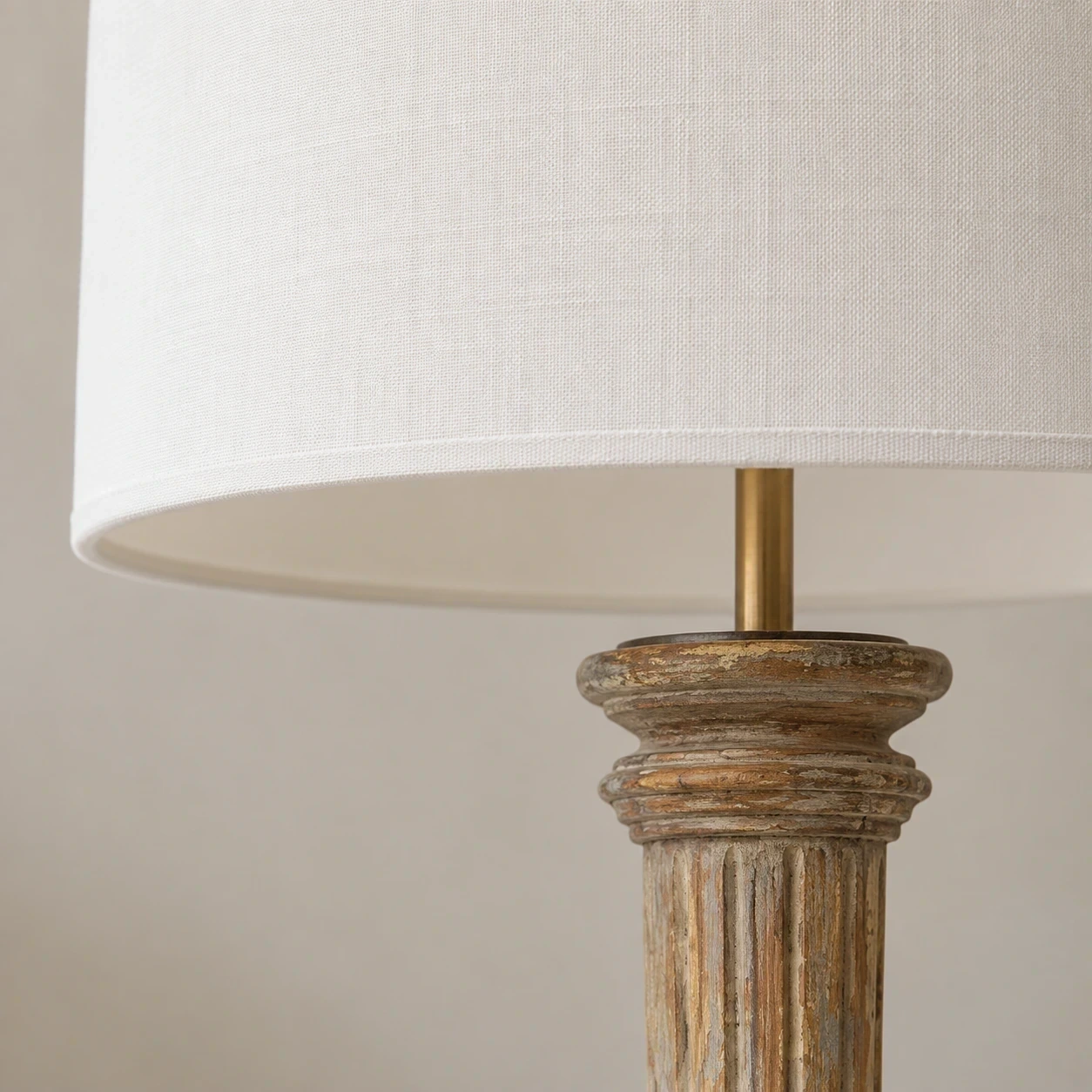Close detail of the fabric shade and upper carved wood pedestal