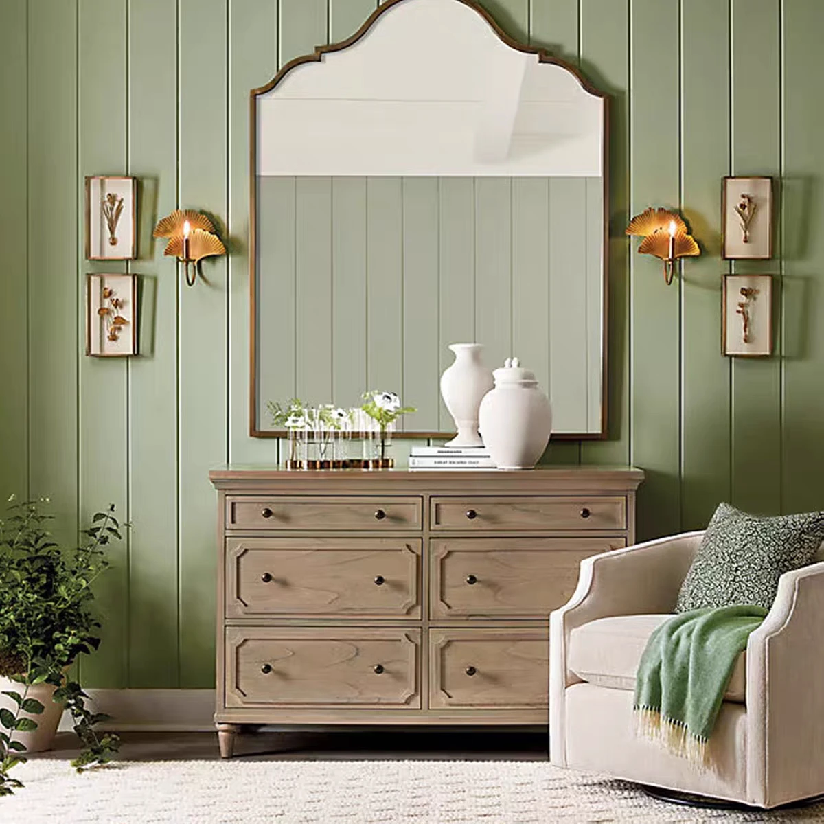 Paired vintage copper ginkgo wall sconces beside a mirror