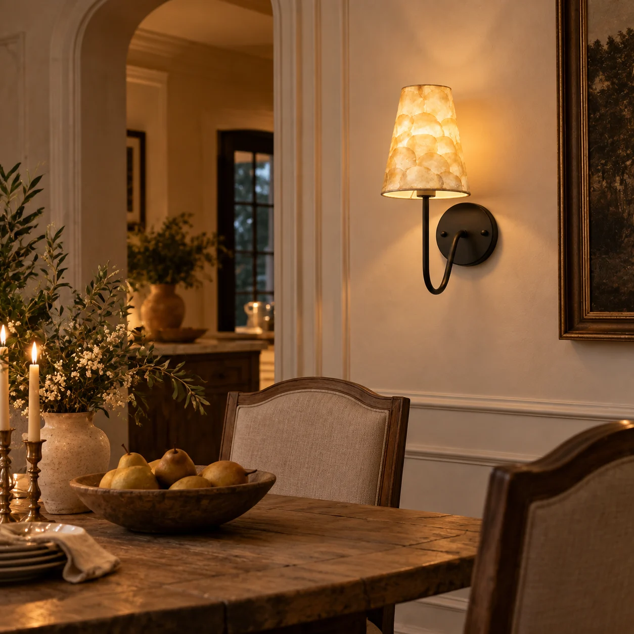 Matte black shell mosaic wall sconce in a dining room