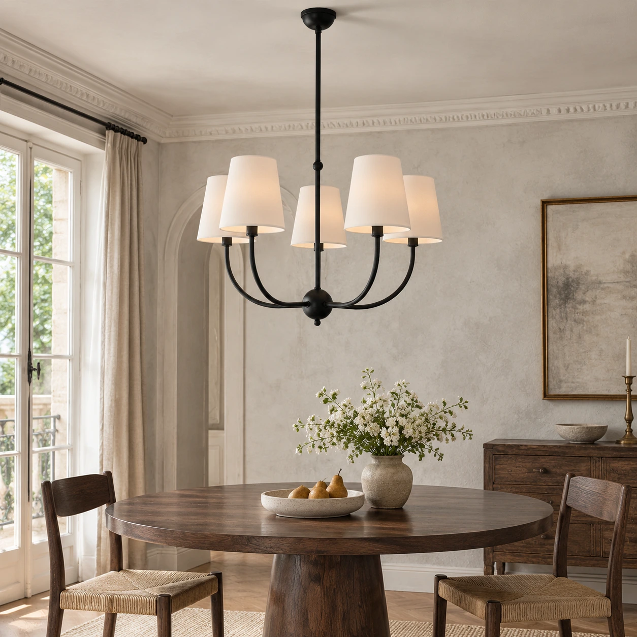 Vintage branch chandelier with fabric shades installed above a dining table