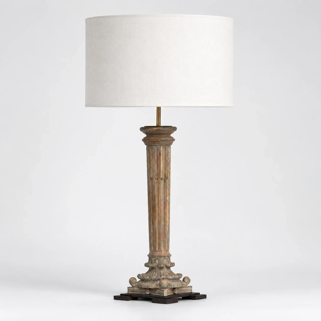 Aveline carved wood table lamp switched off in a neutral studio