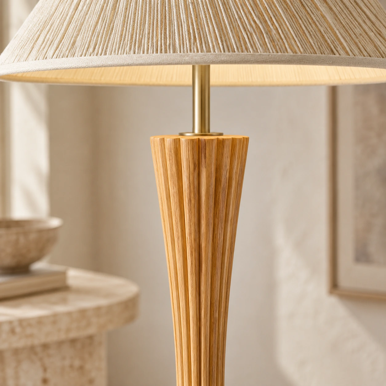 Close view of the Elodie lamp's metal stem entering the fluted carved wood neck