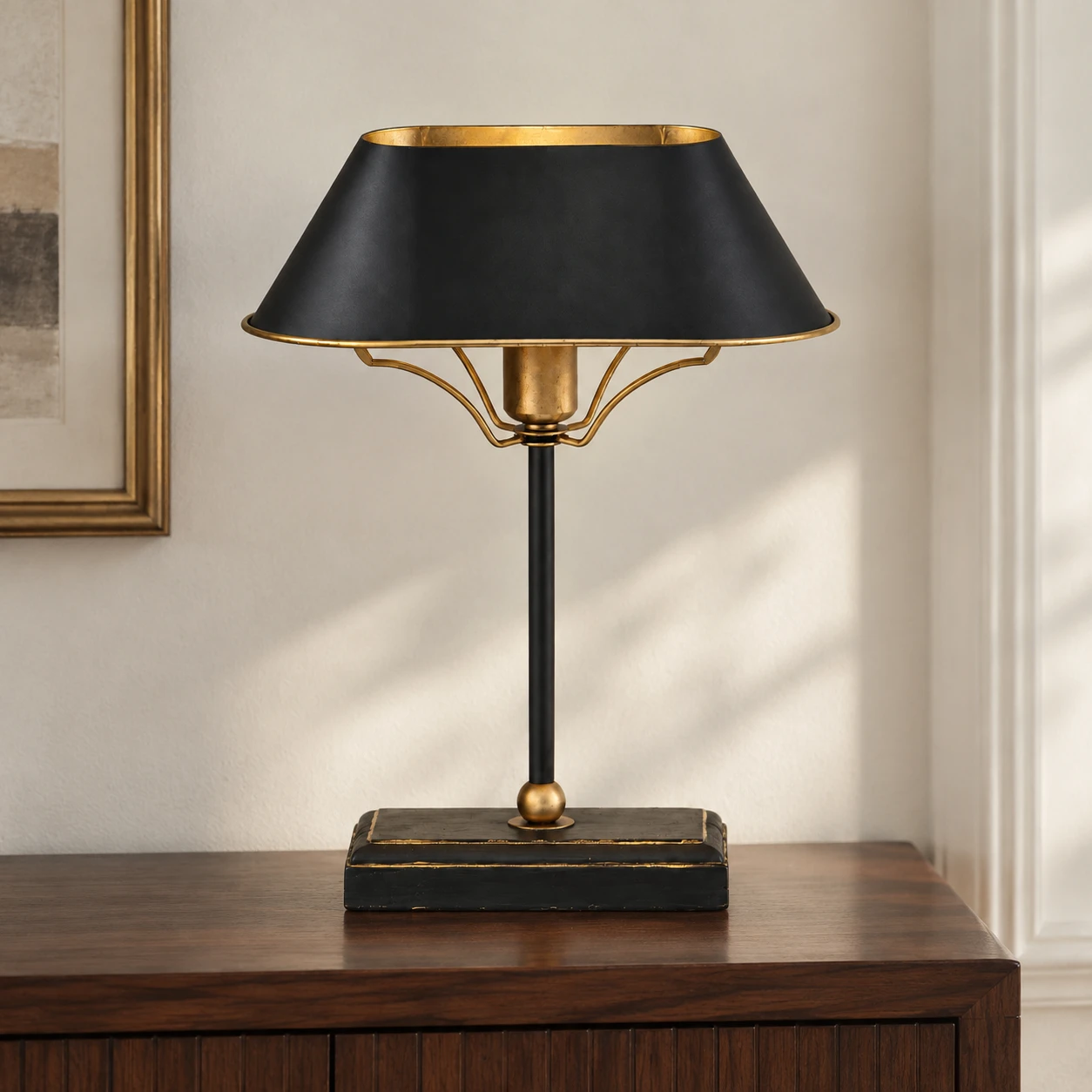 Black and gold French vintage table lamp centered on a walnut sideboard