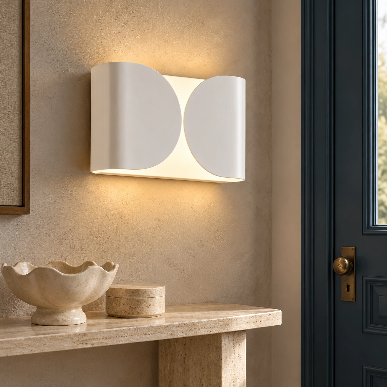 White Foglio wall light in an entry console setting