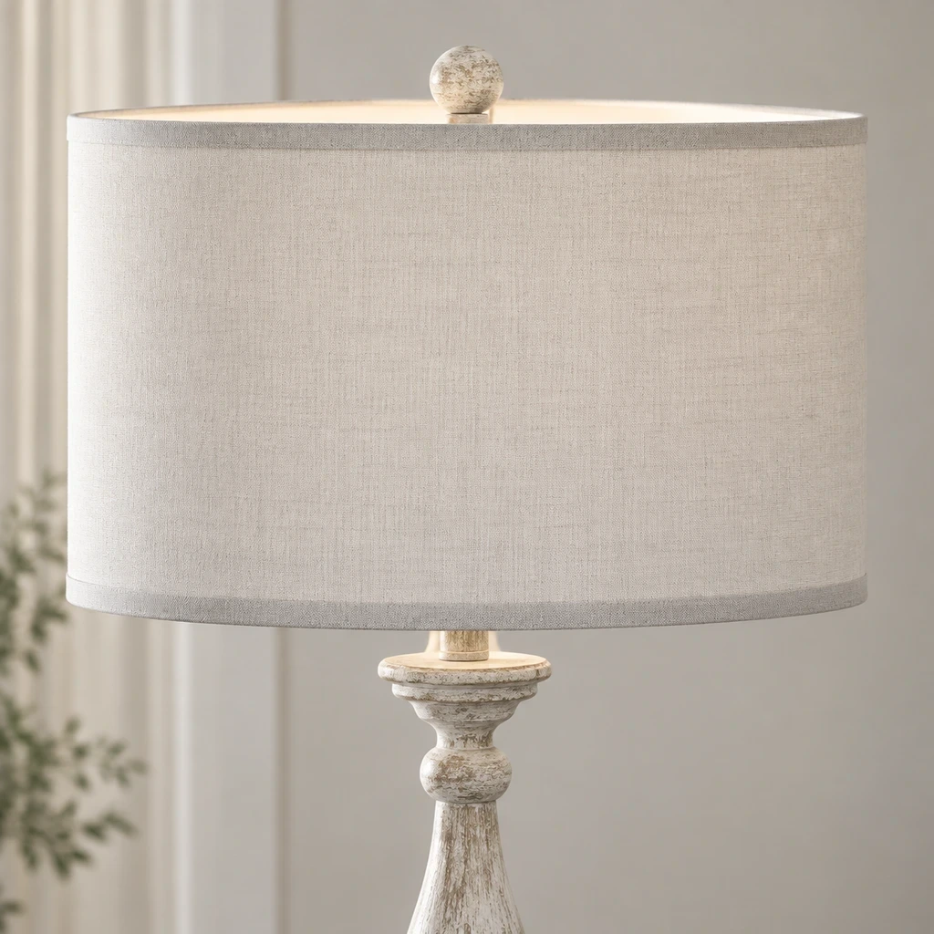 Close detail of the small finial, linen shade edge and carved floral collar
