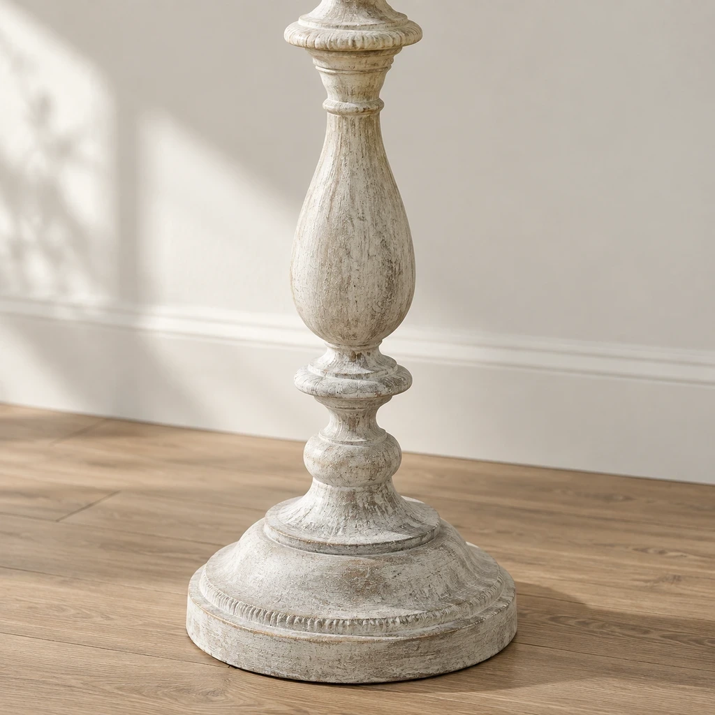 Close detail of the linen shade, carved petal panel and rounded pedestal