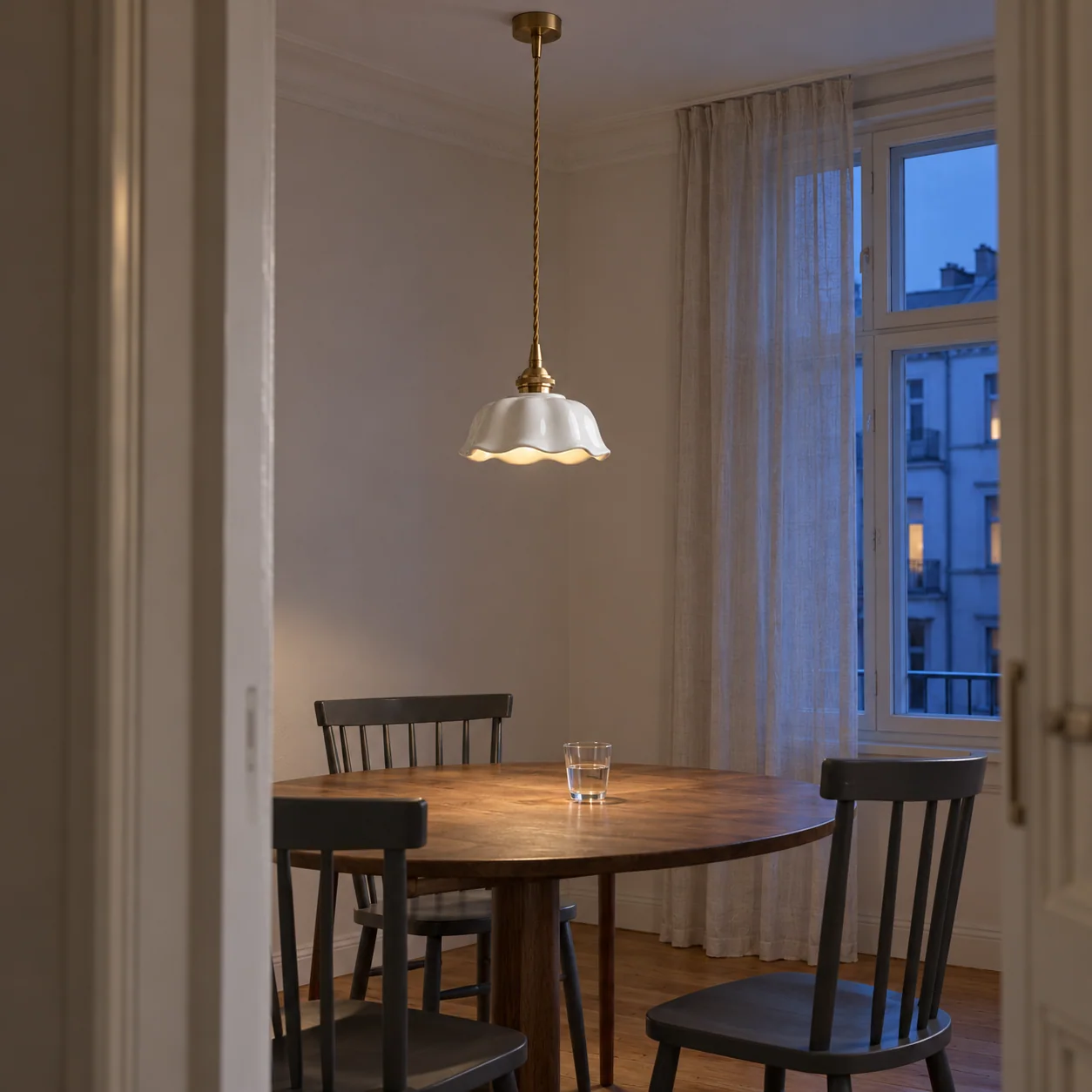 Flower pendant above a dining table at dusk
