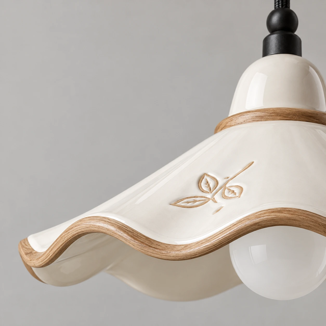 Close view of the scalloped ceramic rim and white-ash wood trim