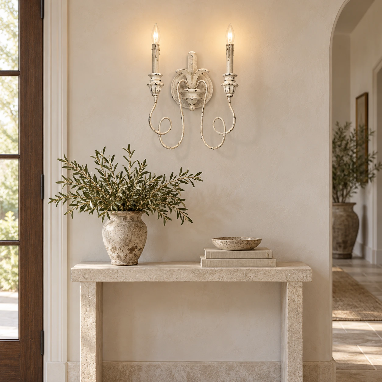 Cassia white aged wall sconce above a pale limestone entry console