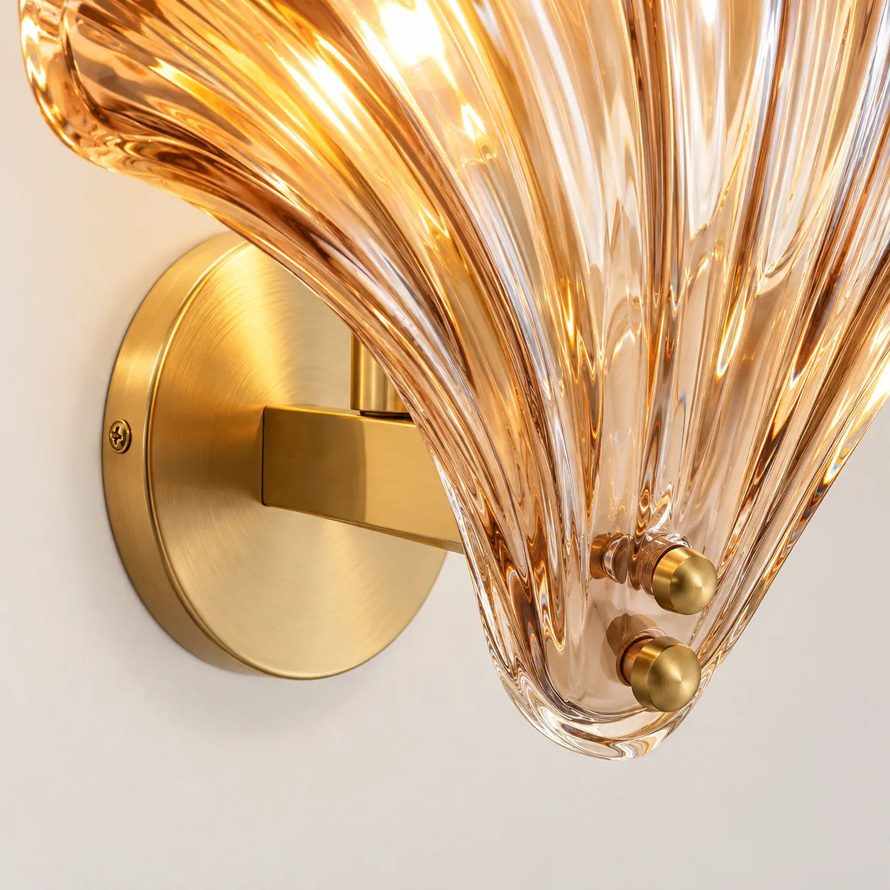 Close-up of the brass wall plate and shell mounting connection