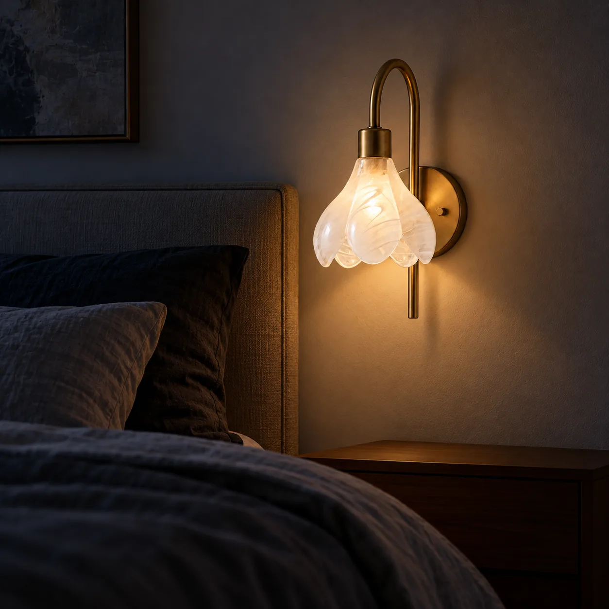 Wall sconce beside a bed at night
