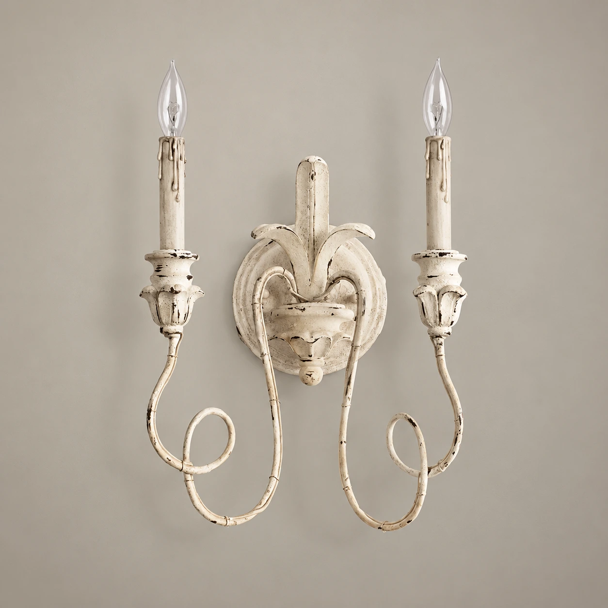 Cassia white aged wall sconce switched off in a neutral studio