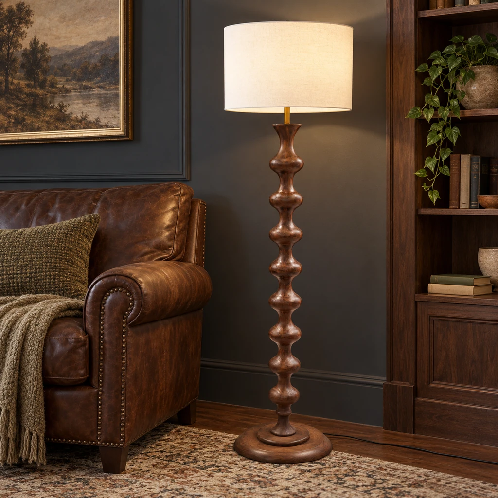 Avery sculpted walnut wood floor lamp beside a leather reading chair